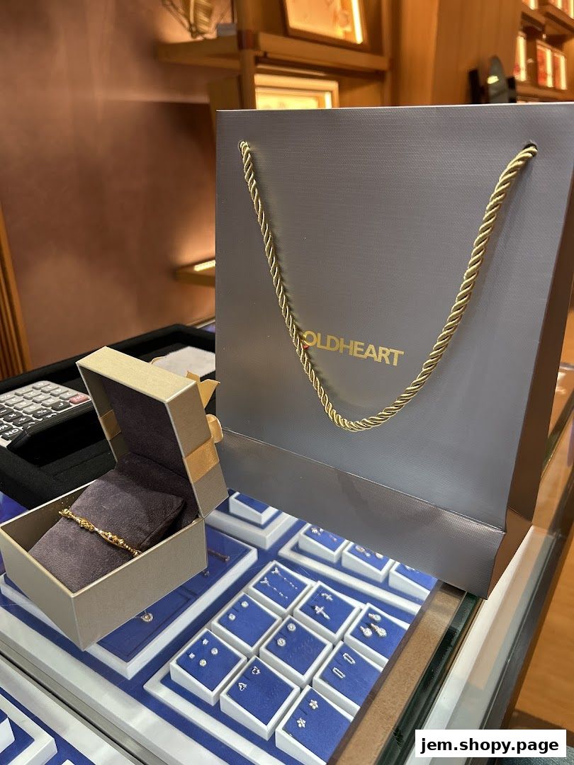 A jewelry display case with a Goldheart shopping bag and an open jewelry box.