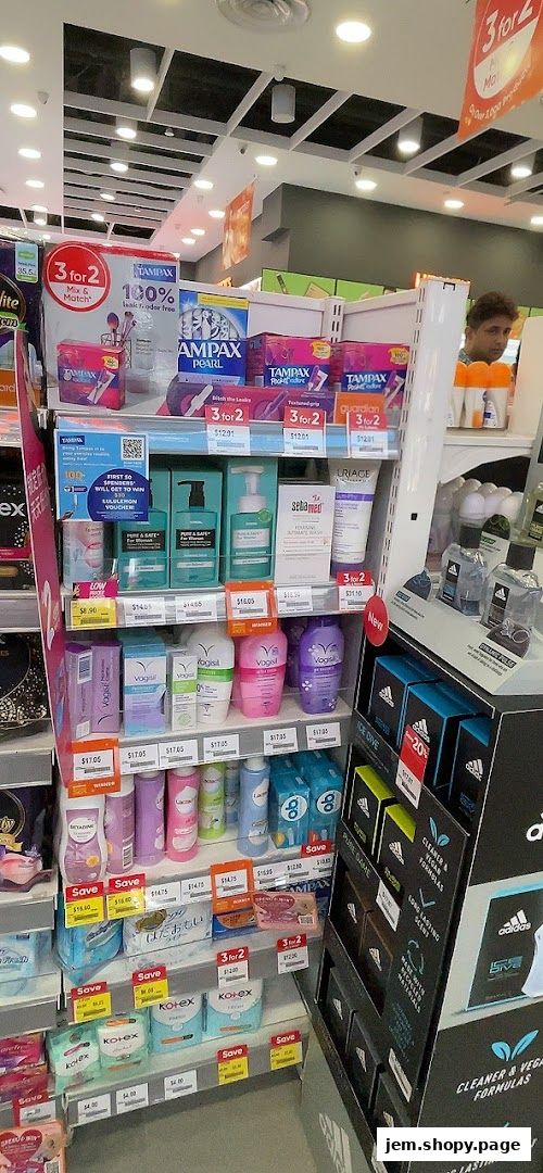 A retail display featuring feminine hygiene products, skincare, and fragrances with promotional signage.