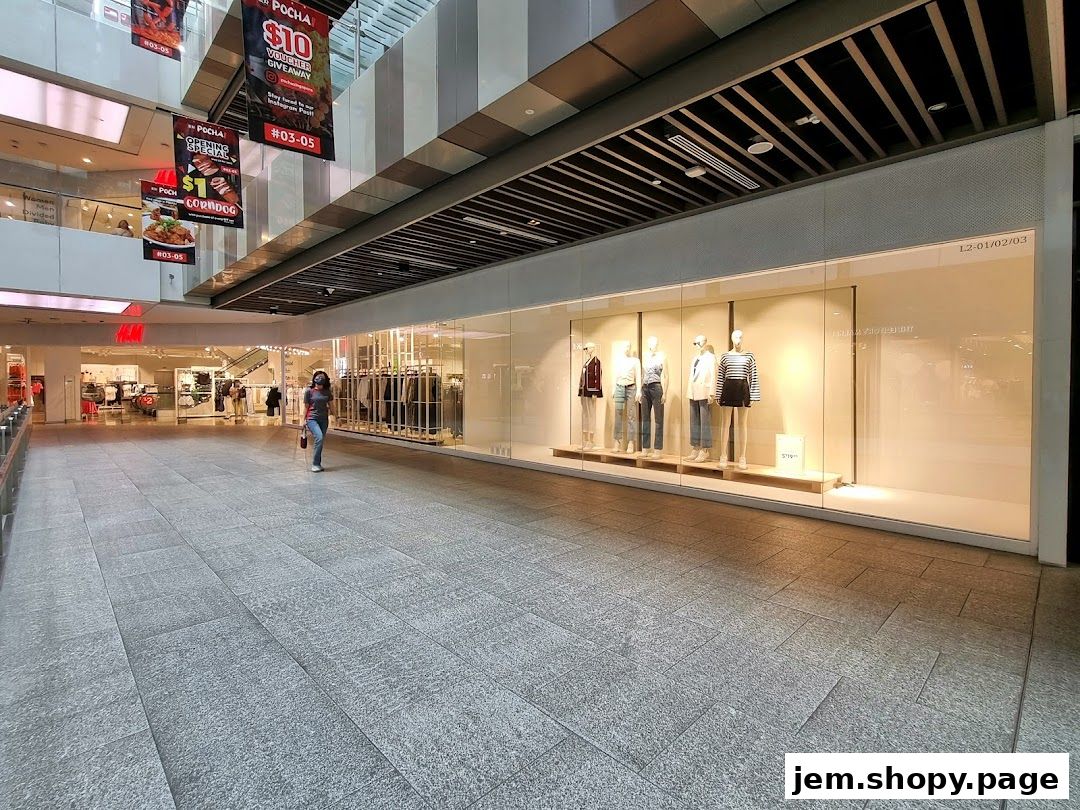 The H&M store entrance and display window with mannequins in a shopping mall.
