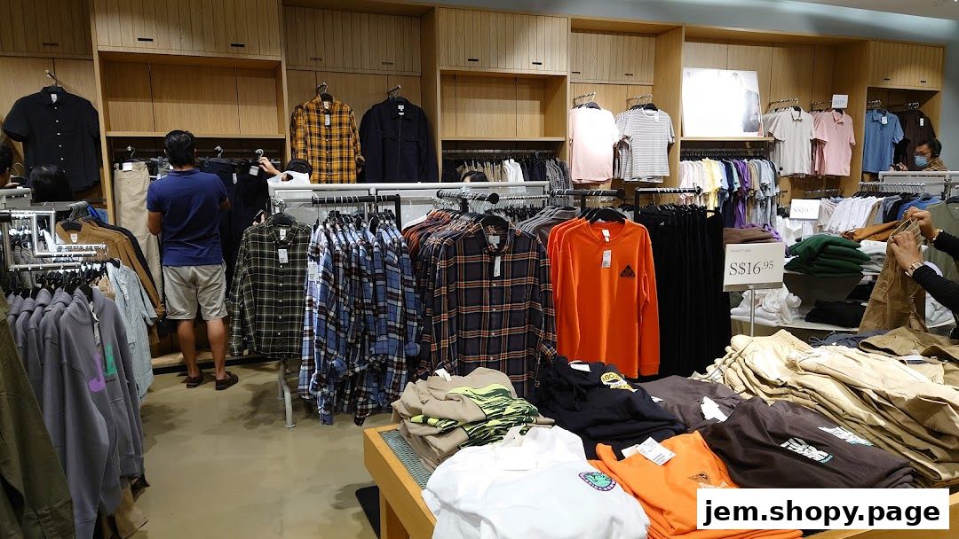 Interior view of an H&M store showcasing a variety of men's clothing, including shirts and pants.