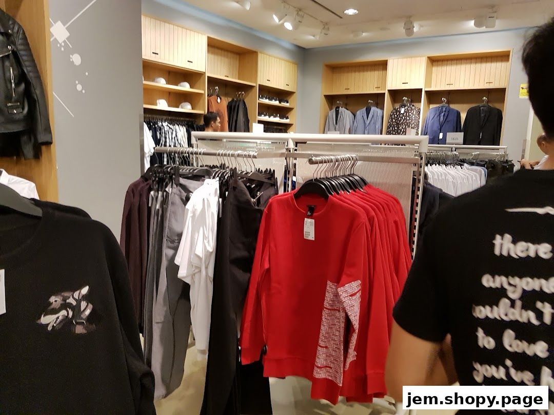Interior view of an H&M store showcasing clothing racks with various apparel and display shelves.