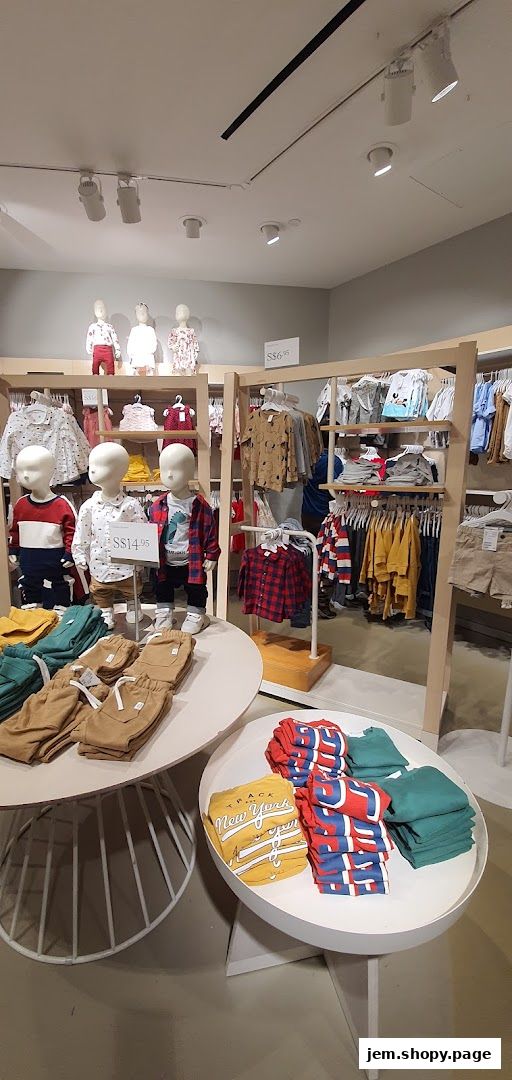 Children's clothing displayed on mannequins and racks inside an H&M store.