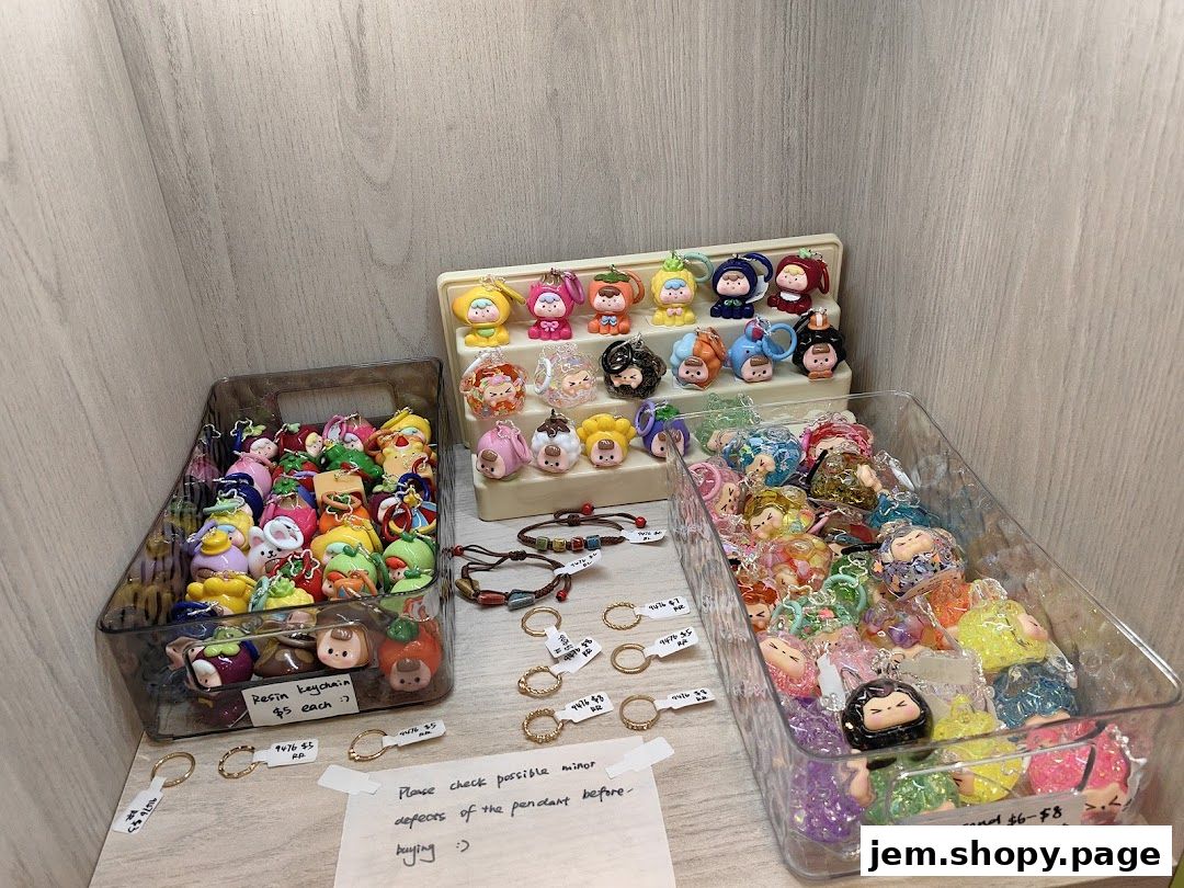 A display of colorful resin keychains and pendants in various designs.