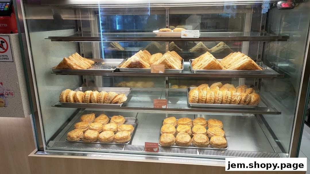 A display case filled with various savory pies and pastries from Hans Union.