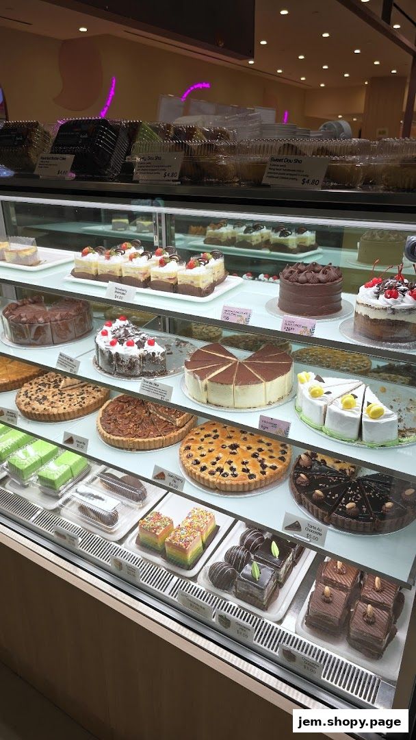 A display case filled with a variety of delicious cakes, pastries, and pies.