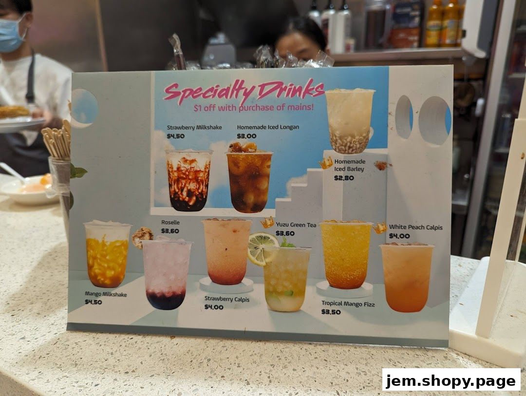 A menu board displaying specialty drinks with images and prices.