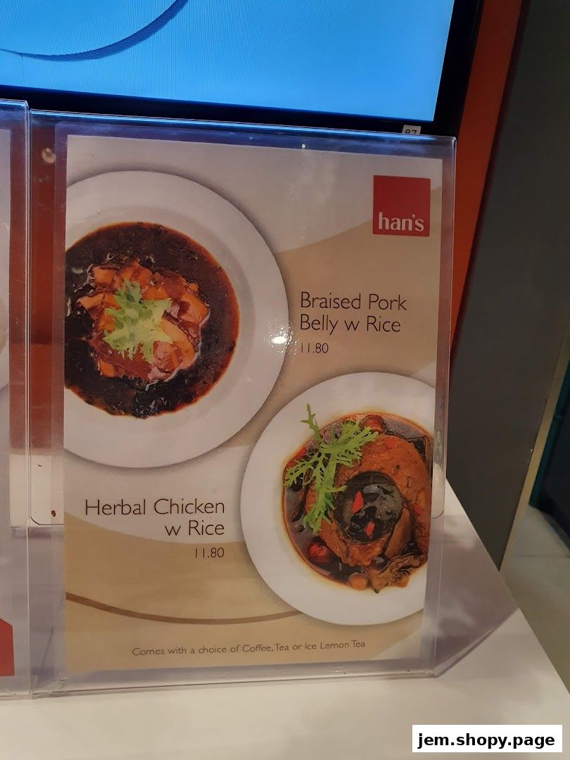 A menu display featuring Braised Pork Belly w Rice and Herbal Chicken w Rice.