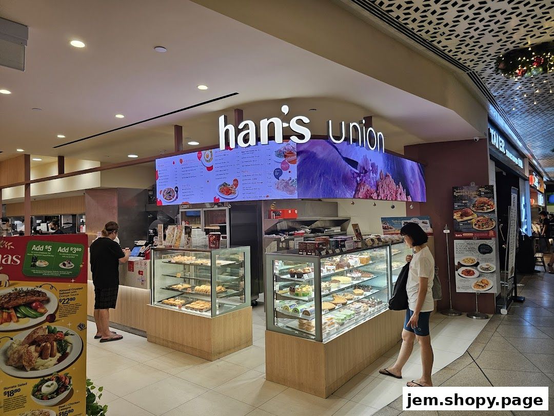 Hans Union shop with display cases of pastries and a digital menu board.