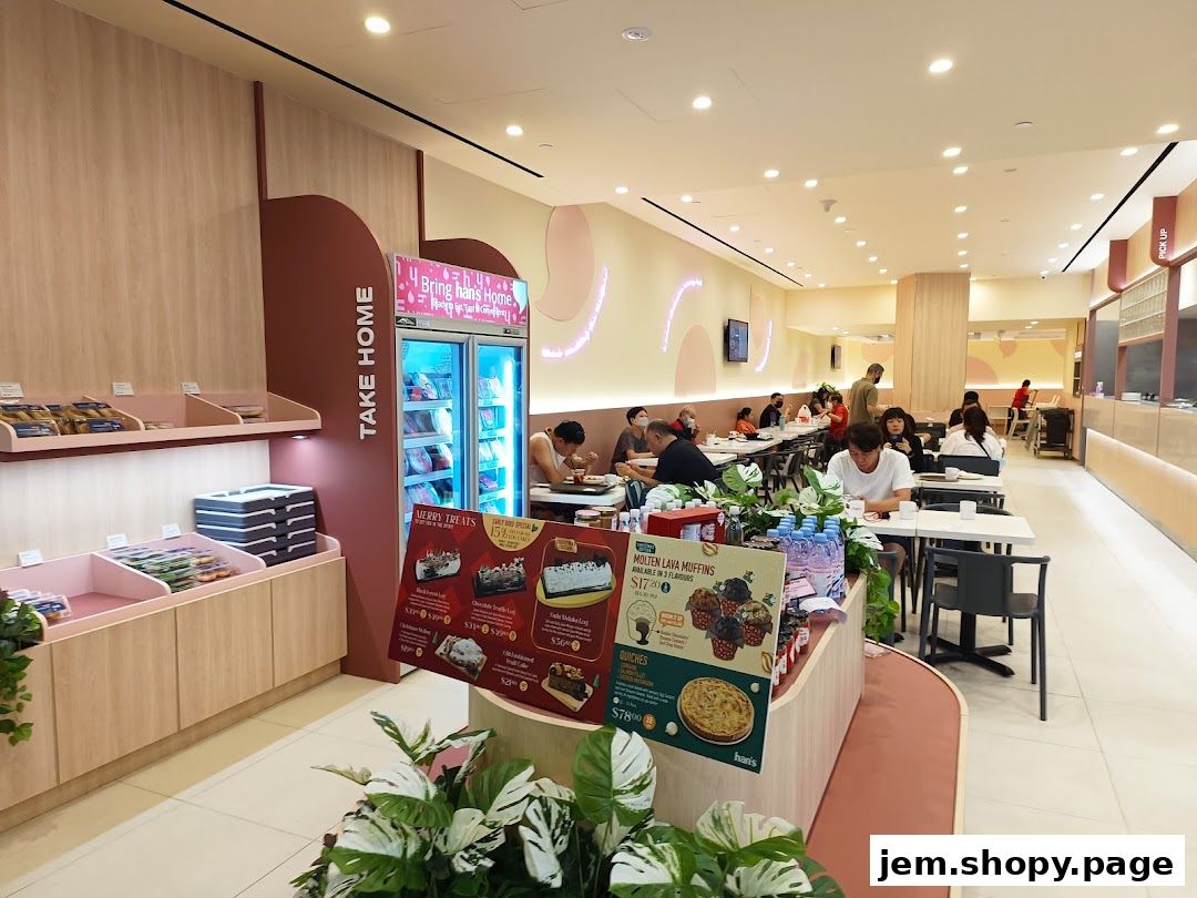 Interior view of Hans Union bakery with customers dining and display shelves.