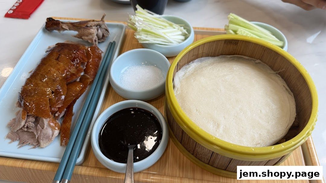 A platter of Peking duck with accompaniments like pancakes, scallions, and sauce.