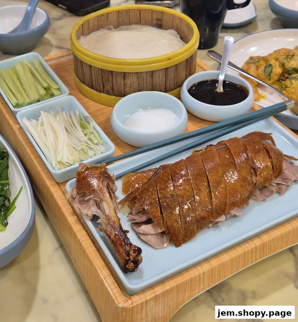 A platter of Peking duck with accompaniments like pancakes, cucumber, and scallions.