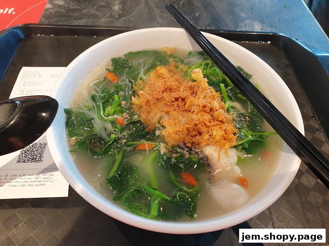 A bowl of handmade noodles with fish, vegetables, and crispy toppings.