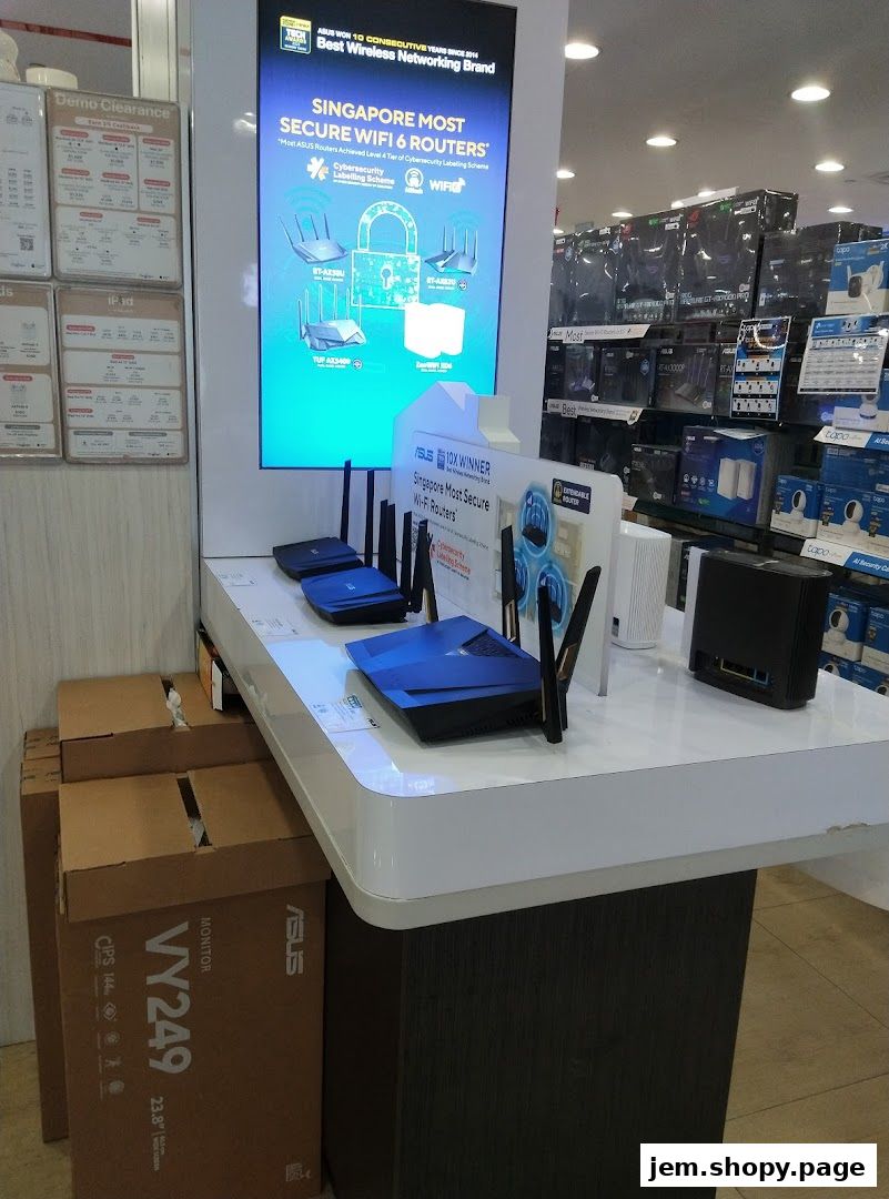 Display of ASUS Wi-Fi 6 routers and other networking equipment in a retail store.