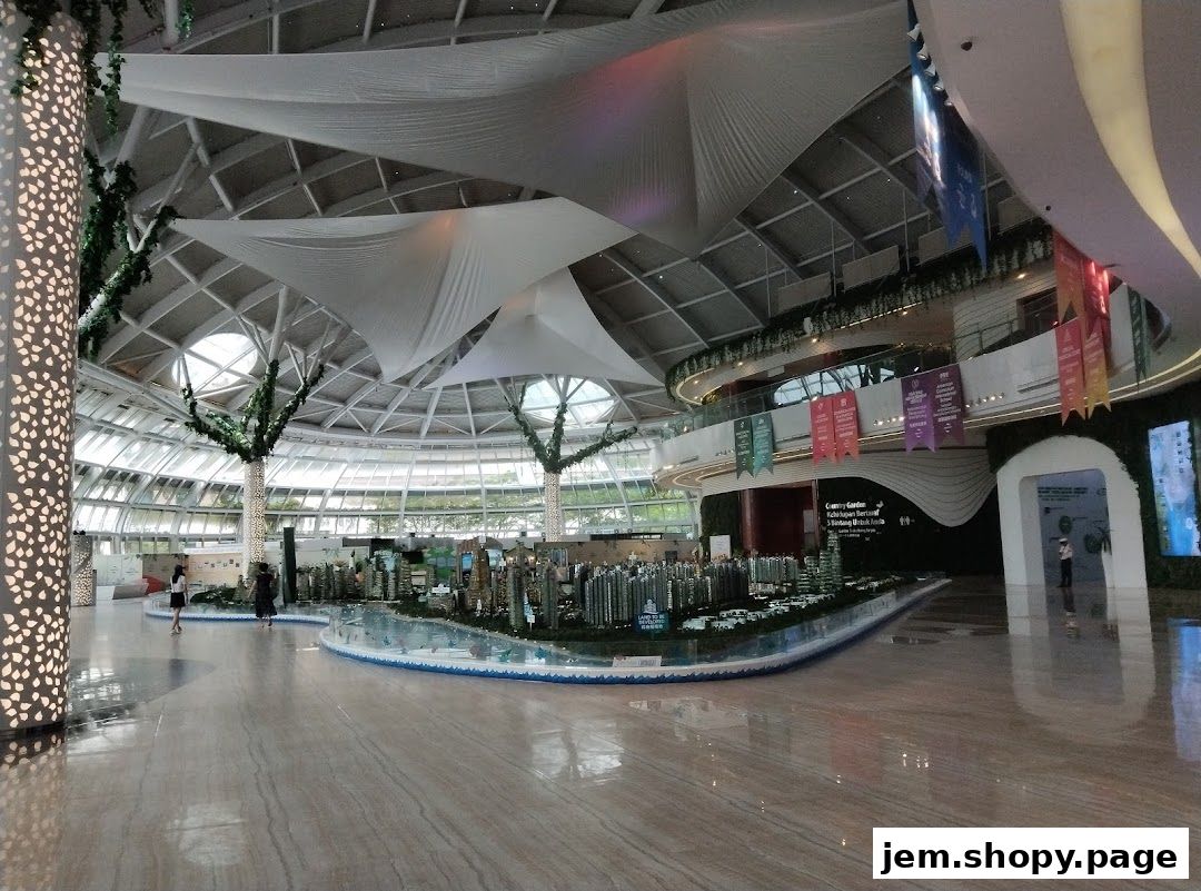 Spacious interior of a modern building with a large architectural model and decorative elements.
