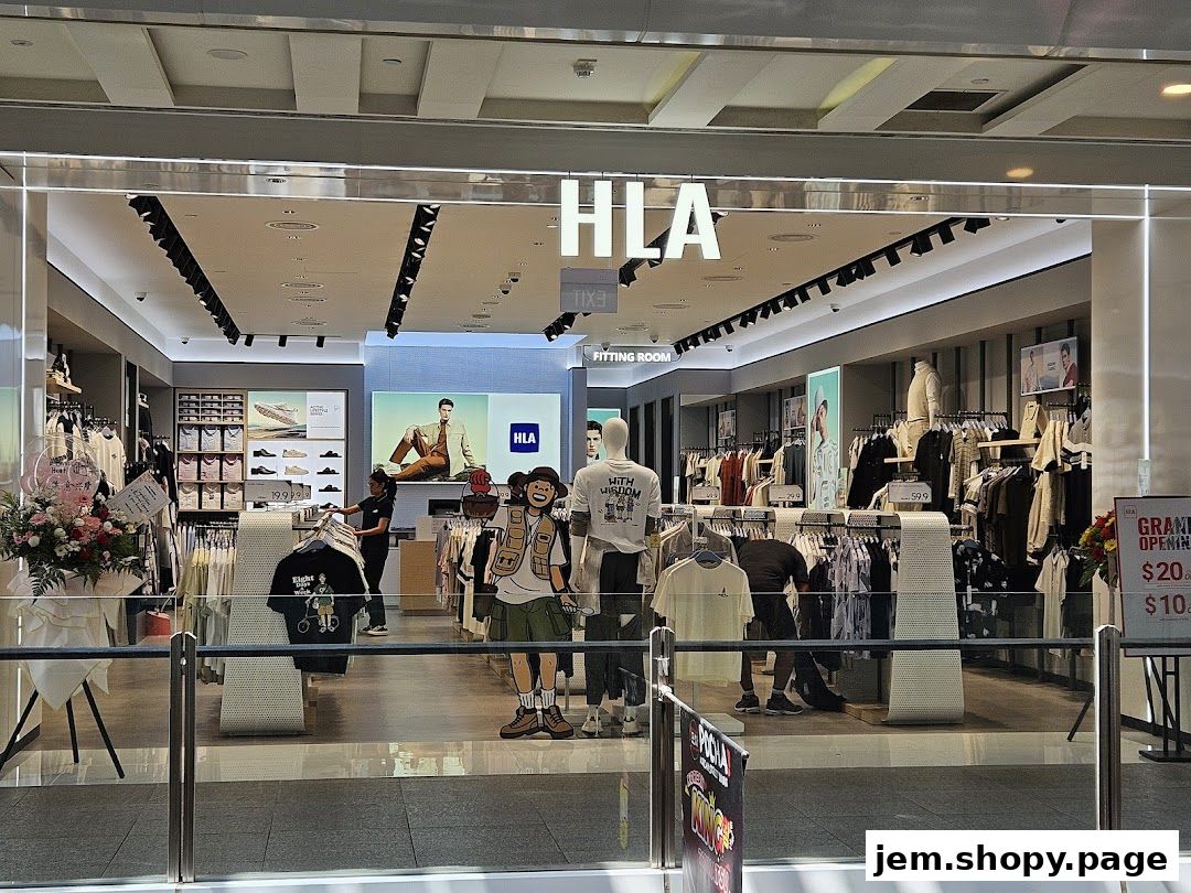 The entrance of the HLA JEM clothing store, showcasing apparel and mannequins.