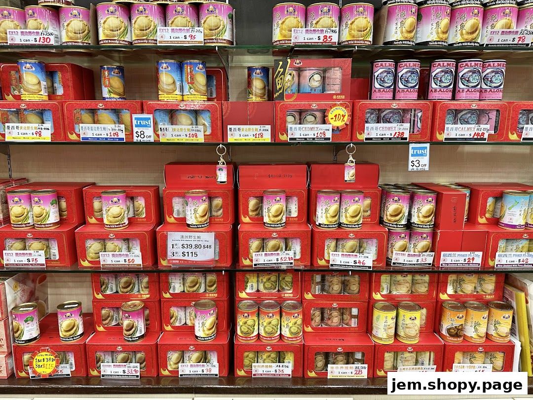 Shelves stocked with various canned abalone products in red packaging.
