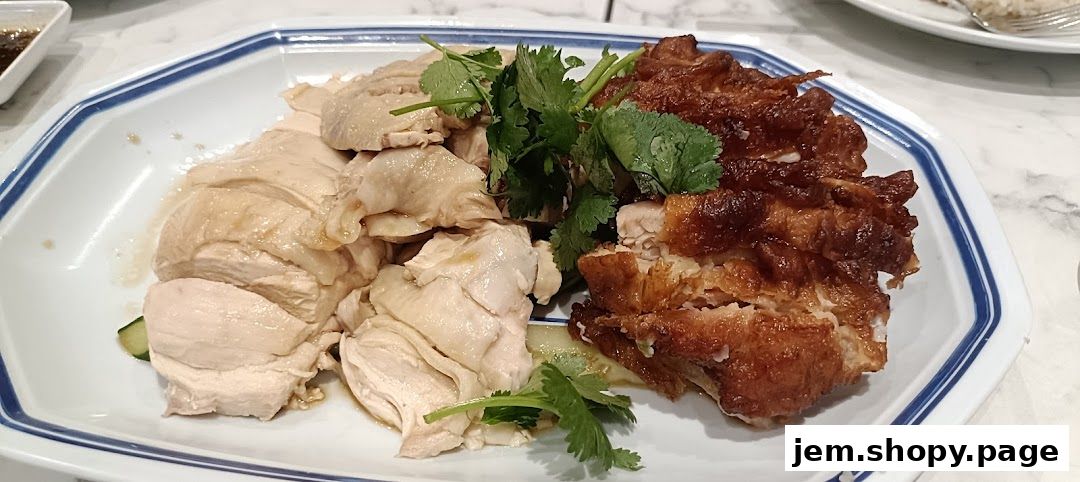 A plate of Hainanese chicken rice with both steamed and roasted chicken.