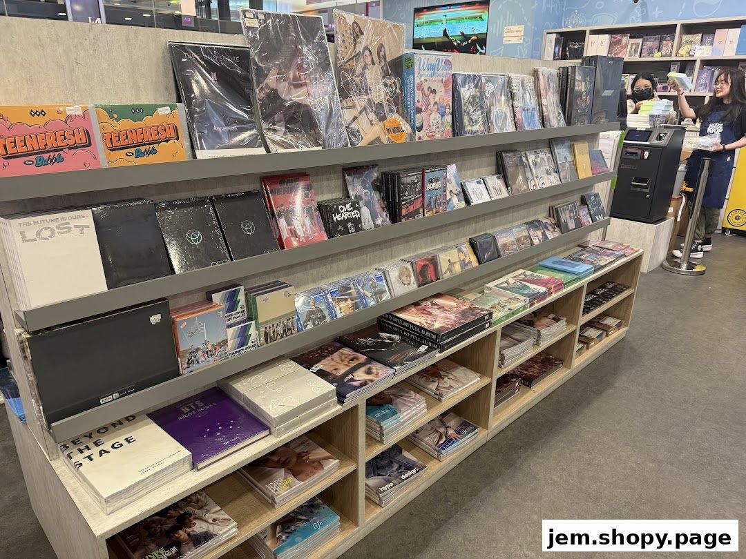 Shelves filled with K-pop albums, merchandise, and photo books in a retail store.