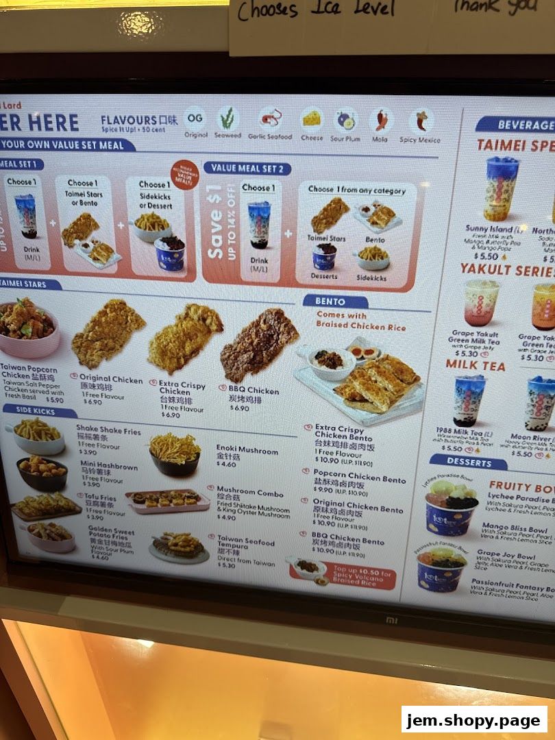 A digital menu board displaying various fried chicken, bento boxes, drinks, and desserts.