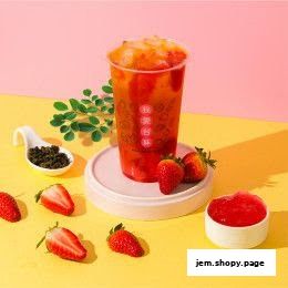 A refreshing strawberry bubble tea with fresh strawberries and tea leaves.