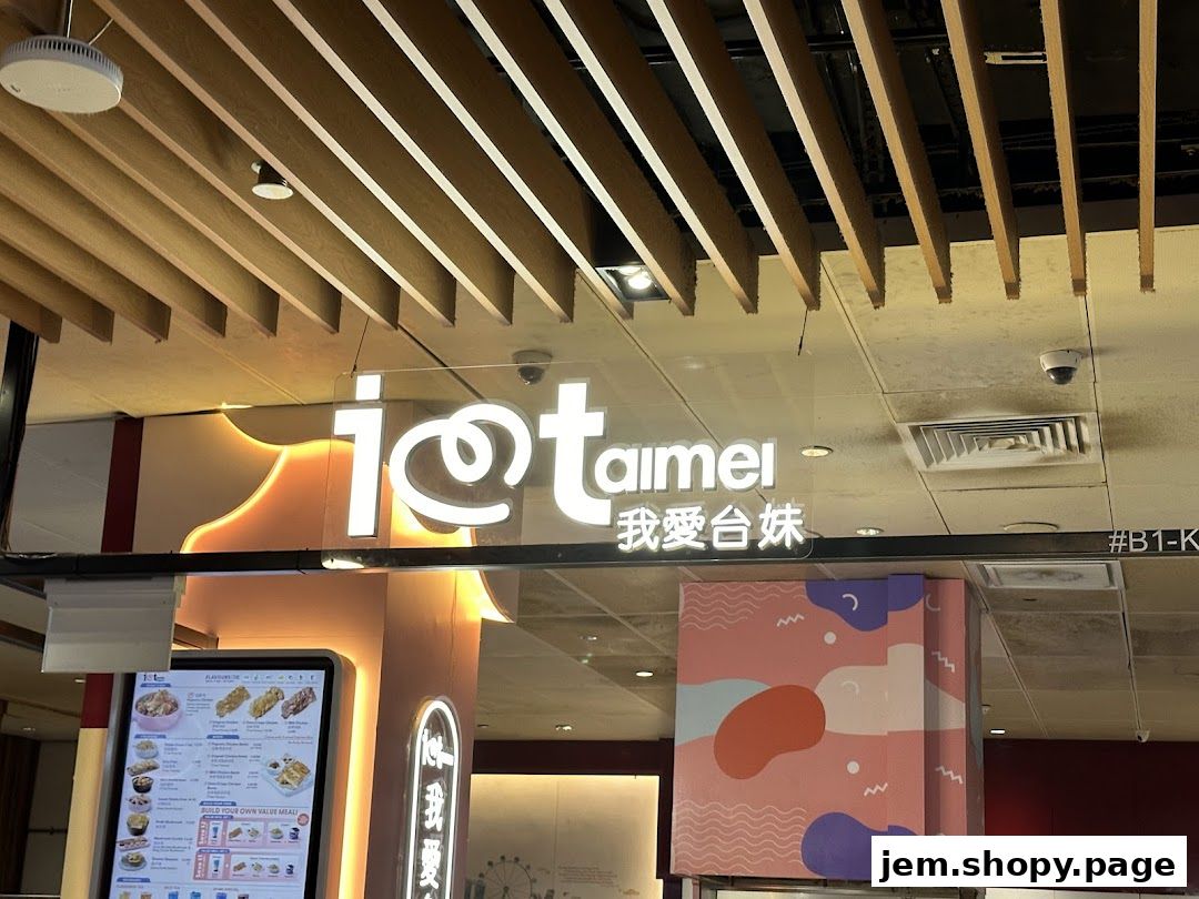 The illuminated sign for 'I Love Taimei' with Chinese characters and a digital menu display.