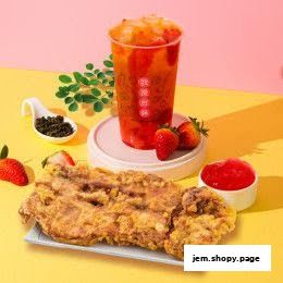 A crispy fried chicken cutlet with a strawberry bubble tea and fresh strawberries.