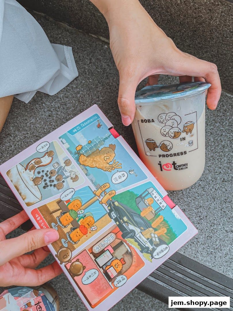 A hand holds a bubble tea cup next to a comic-style booklet from I Love Taimei.