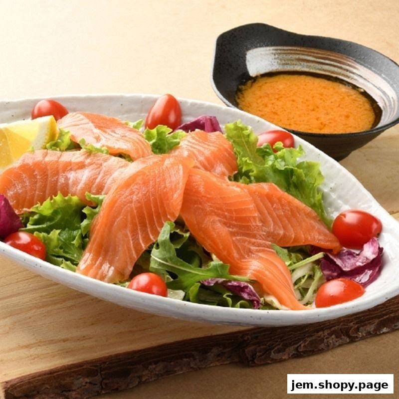 A fresh salmon salad with cherry tomatoes and lettuce, served with dressing.