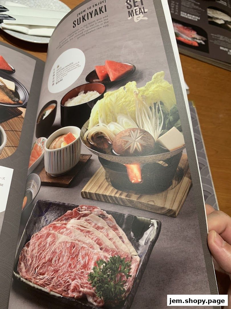 A menu page showcasing a Sukiyaki Set Meal with raw beef and vegetables.