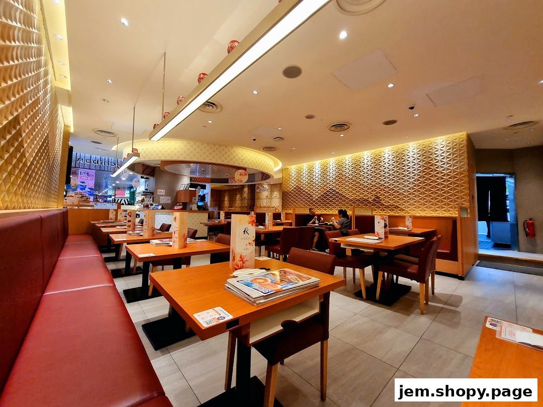 Interior view of a Japanese restaurant with tables, booths, and decorative walls.