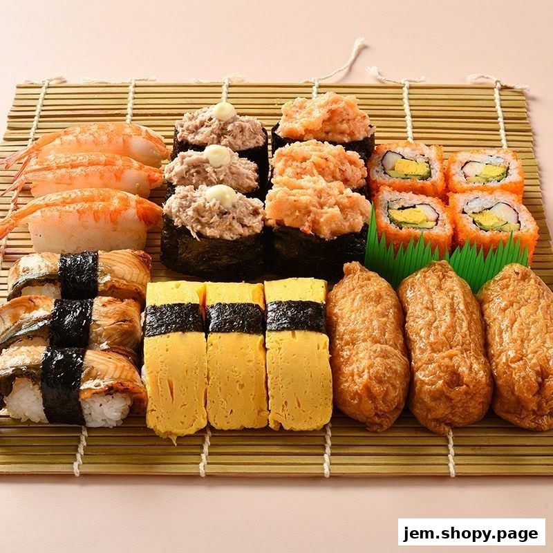 A variety of sushi and inari on a bamboo mat.