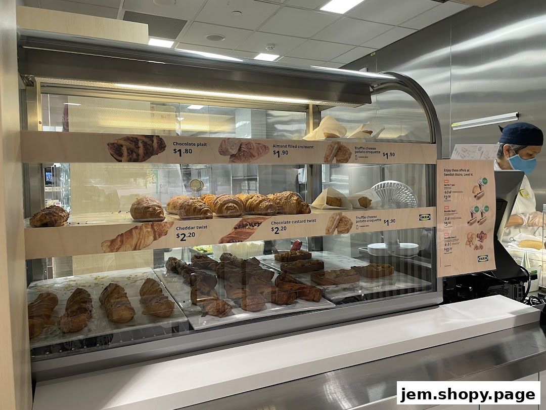 A display case filled with various pastries and baked goods at IKEA Jurong Restaurant.
