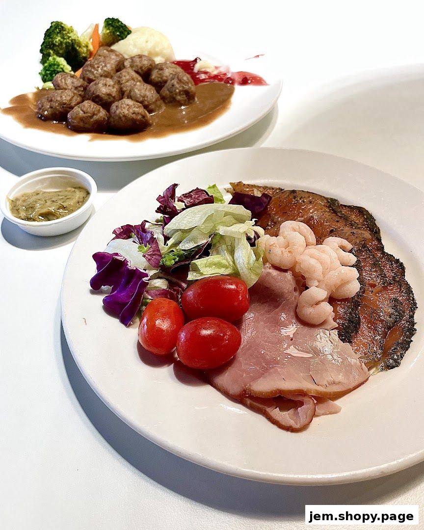 Two plates of food, one with meatballs and vegetables, the other with salad, ham, and shrimp.