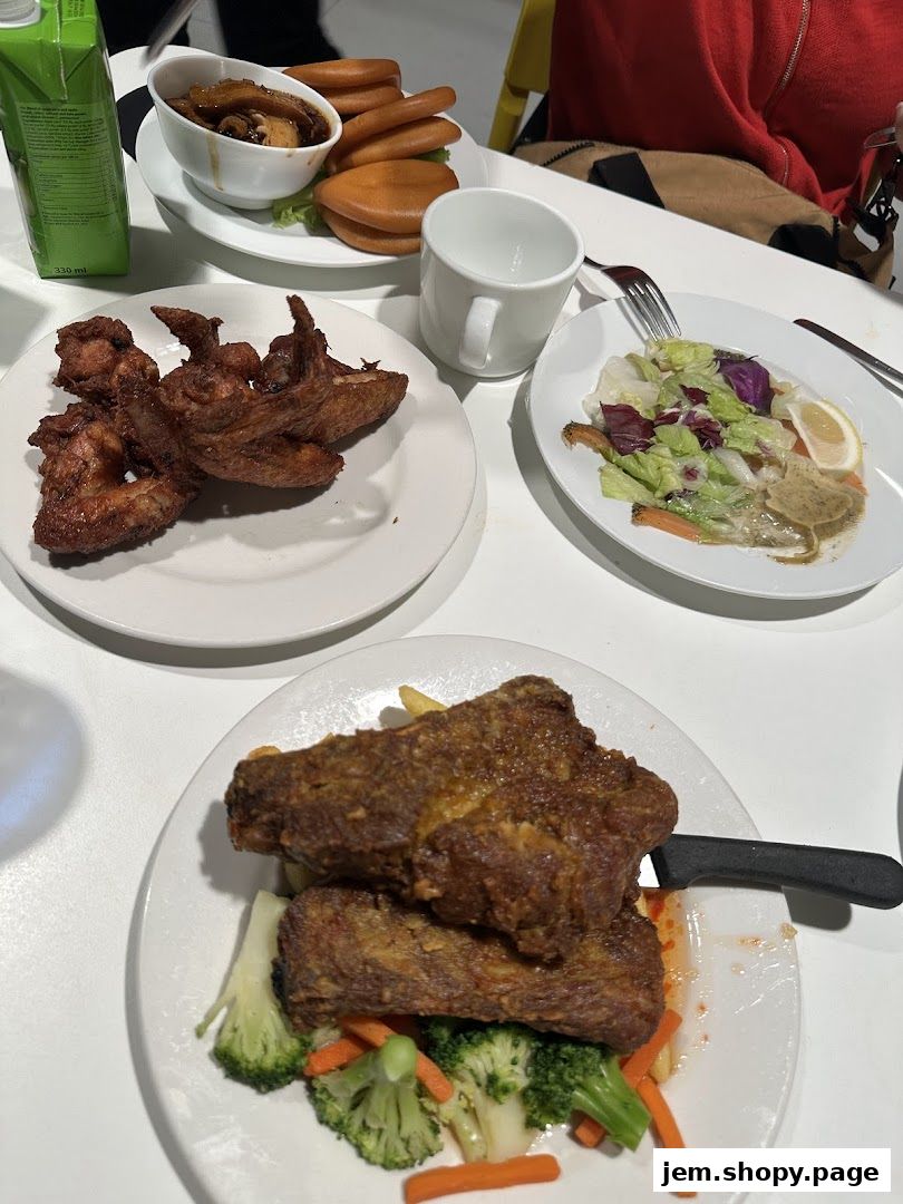 A table laden with various dishes including fried chicken, salad, and a burger.