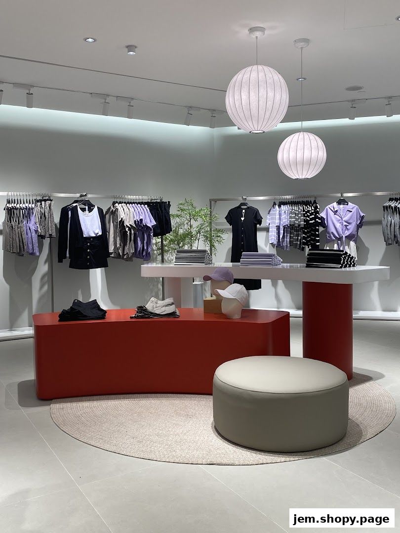 Interior view of a clothing store with apparel displayed on racks and mannequins.
