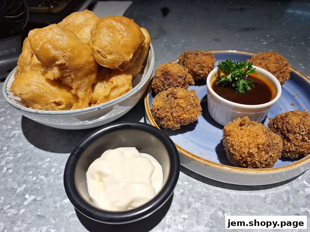 A close-up of two different types of fried appetizers served with dipping sauces.