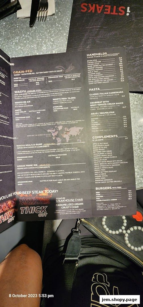 A menu from iSTEAKS Jem featuring various steak cuts, handhelds, pasta, and burgers.