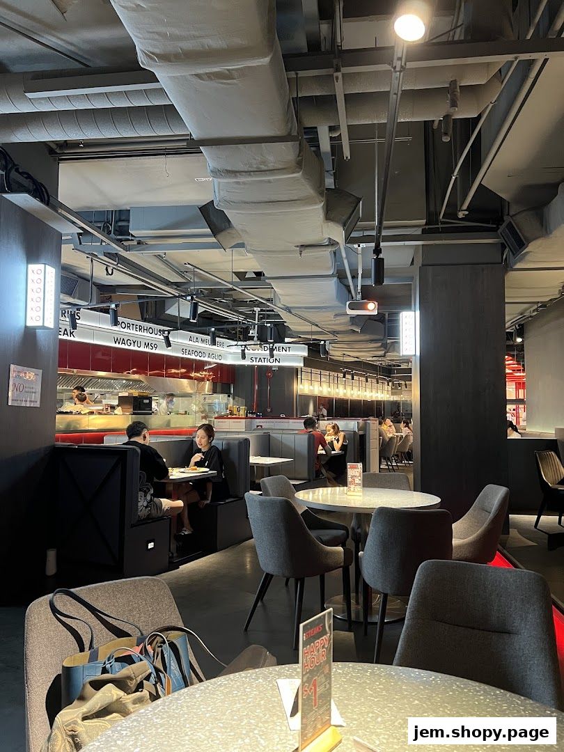 Interior view of iSTEAKS restaurant with diners seated at tables and an open kitchen.