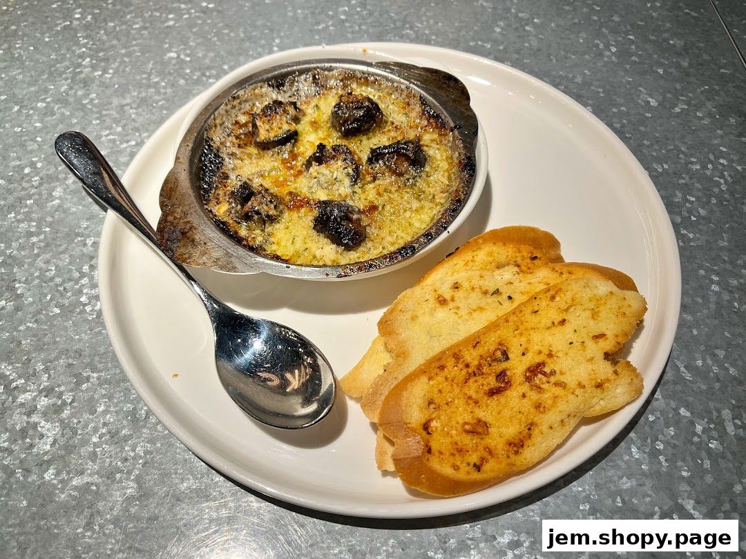 A dish of escargots with garlic butter and herbs, served with toasted bread.