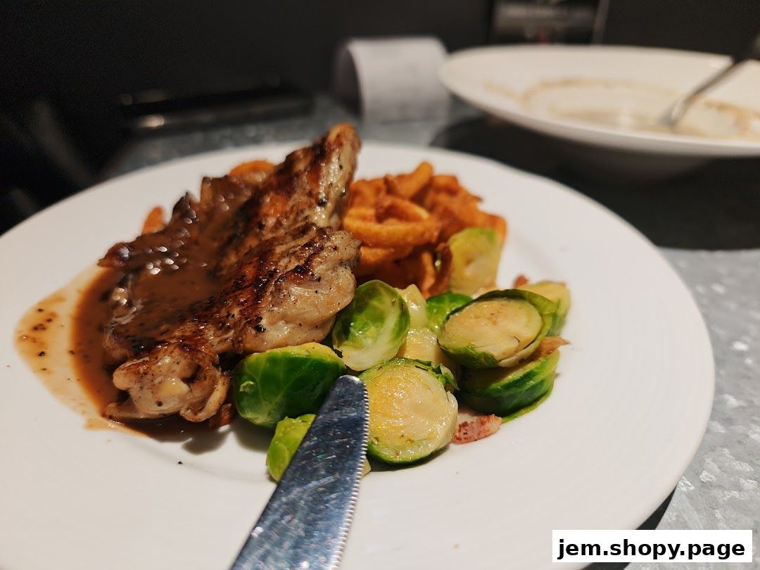A grilled steak with Brussels sprouts and fries served on a white plate.