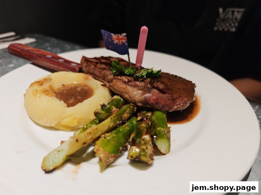 A juicy steak with mashed potatoes, asparagus, and a New Zealand flag.