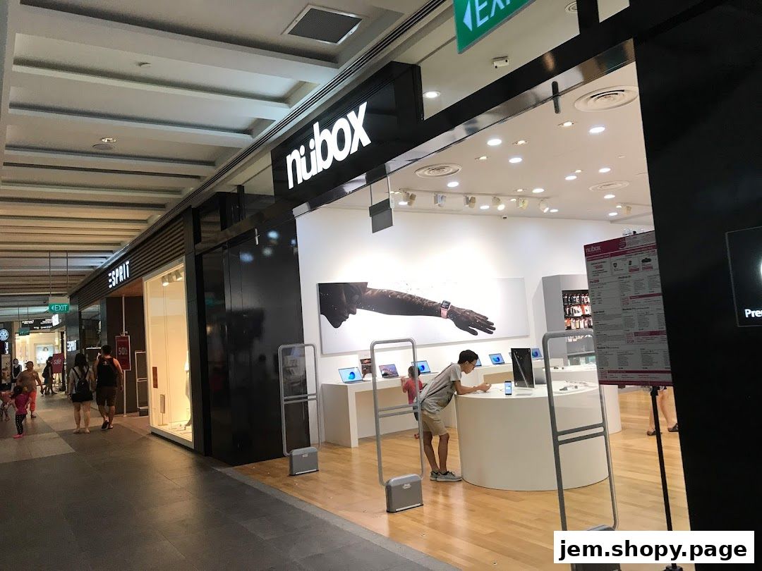The exterior of the nubox electronics store with displays and a person browsing.