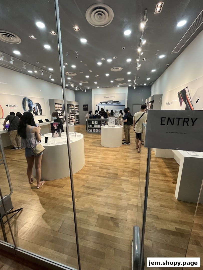 Interior view of an iStudio electronics store showcasing Apple products and displays.