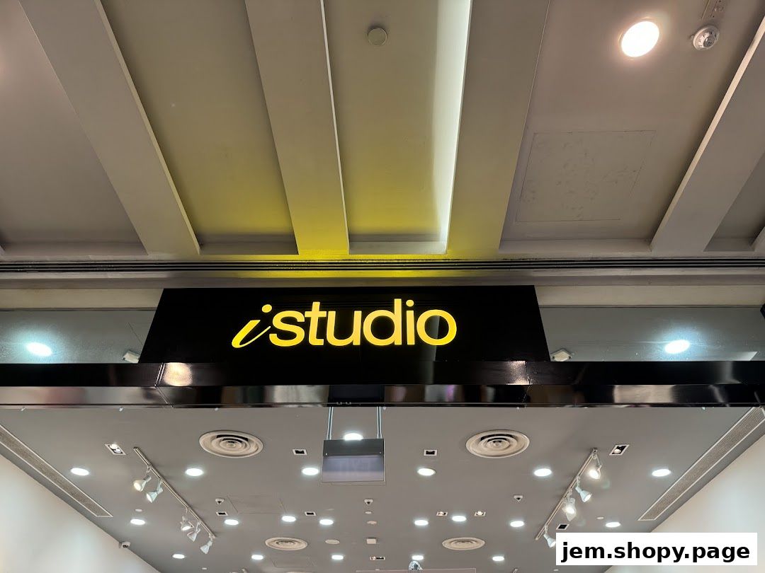 The illuminated 'iStudio' logo is displayed prominently on a black sign above the shop entrance.