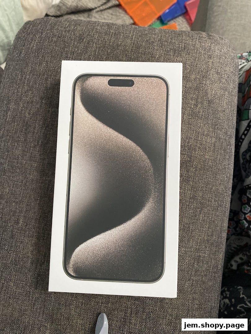 A box with an iPhone 14 Pro on a textured gray surface.