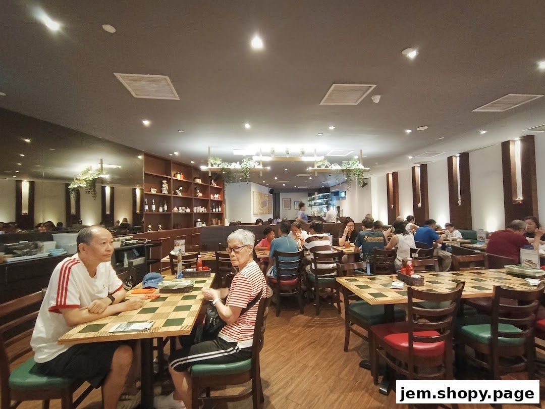 Interior of a busy restaurant with diners seated at tables.