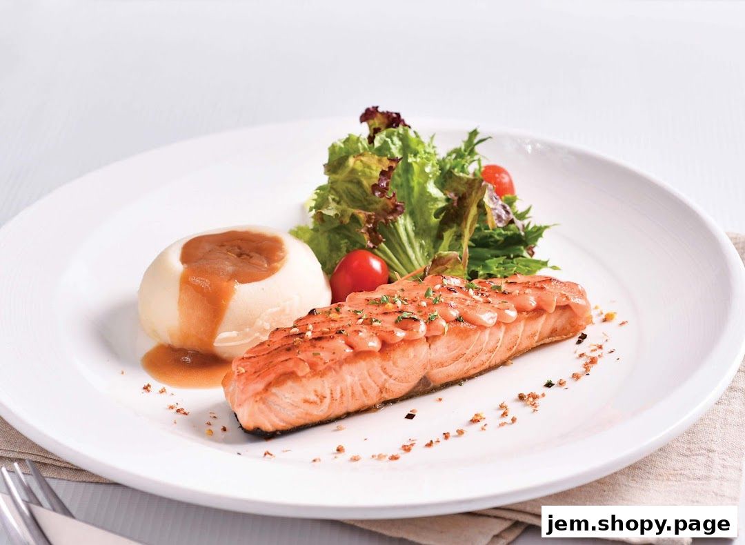 A perfectly grilled salmon fillet served with mashed potatoes and a fresh salad.
