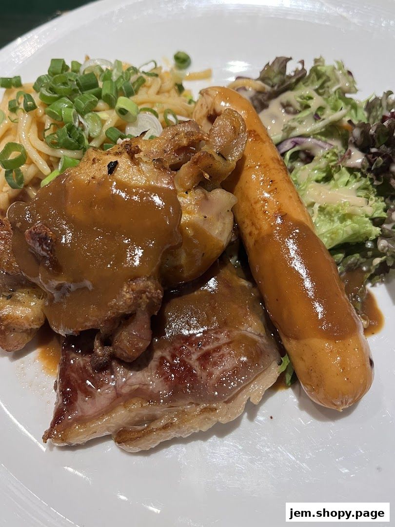 A plate of food featuring chicken, sausage, noodles, and salad.