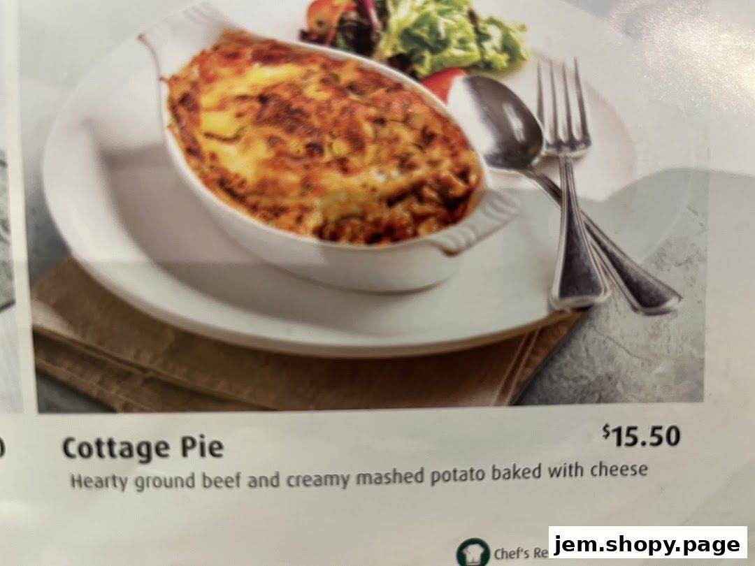 A close-up of a Cottage Pie dish with a side salad and cutlery, priced at $15.50.