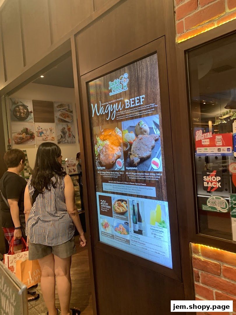 Digital menu board at Jack's Place JEM featuring Wagyu beef and appetizers.